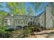 View of the home's expansive backyard with trees and deck and sunroom from the lawn at 770 Raleigh Sw Ct, Marietta, GA 30064