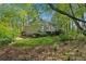 Secluded backyard surrounded by lush trees and landscaping, and a partial view of the home at 770 Raleigh Sw Ct, Marietta, GA 30064