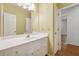Bathroom featuring white cabinets, an extended vanity and a large mirror at 770 Raleigh Sw Ct, Marietta, GA 30064