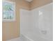 Bright bathroom with white tiled shower over tub and natural light from the window at 770 Raleigh Sw Ct, Marietta, GA 30064
