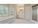 Bathroom featuring a soaking tub, double windows, vanity, and shower at 770 Raleigh Sw Ct, Marietta, GA 30064