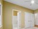 A bright carpeted bedroom has a ceiling fan, closet, and attached bathroom at 770 Raleigh Sw Ct, Marietta, GA 30064