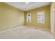 A calming carpeted bedroom features two windows and neutral walls with a ceiling fan at 770 Raleigh Sw Ct, Marietta, GA 30064