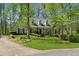 Charming exterior view of the home, manicured lawn, driveway, and mature trees at 770 Raleigh Sw Ct, Marietta, GA 30064