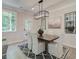 Stylish dining room featuring a dark wood table, seating for six, and decorative light fixture at 116 Winsome Way, Woodstock, GA 30188