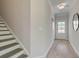 Inviting foyer with a staircase, light gray walls, and a door to the exterior at 116 Winsome Way, Woodstock, GA 30188