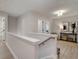 Upstairs hallway featuring a console table with art and a jute rug at 116 Winsome Way, Woodstock, GA 30188