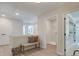 Bright hallway featuring a stylish bench and access to a laundry room and other areas of the home at 116 Winsome Way, Woodstock, GA 30188