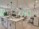 Bright, open living space with a modern island and a flood of natural light through large windows at 116 Winsome Way, Woodstock, GA 30188