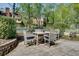 Backyard patio with wood table and chairs amid landscaped plants and grassy lawn at 1802 N Akin Ne Dr, Atlanta, GA 30345