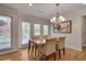 Cozy dining room with hardwood floors, a chandelier, and large windows at 1802 N Akin Ne Dr, Atlanta, GA 30345
