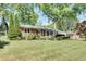 Charming brick home with lush green lawn and mature landscaping at 1802 N Akin Ne Dr, Atlanta, GA 30345