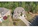 Aerial view of a brick house surrounded by lush landscaping, mature trees, and a spacious driveway at 2564 Walden Estates Dr, Marietta, GA 30062
