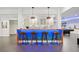Basement bar with wood countertop, blue lighting, modern cabinets, and seating for four on wooden stools at 2564 Walden Estates Dr, Marietta, GA 30062