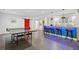 Finished basement with a ping pong table, bar with blue lighting, and red barn door for added charm at 2564 Walden Estates Dr, Marietta, GA 30062