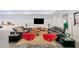 Open concept basement living room with modern furniture, mounted TV, and neutral carpet over dark tile at 2564 Walden Estates Dr, Marietta, GA 30062