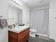 Bright bathroom featuring a modern vanity with wood cabinets and a stylish gray and white chevron shower curtain at 2564 Walden Estates Dr, Marietta, GA 30062