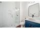 Modern bathroom with sleek glass shower, a vessel sink, blue vanity, and neutral colored floors at 2564 Walden Estates Dr, Marietta, GA 30062