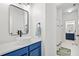 Contemporary bathroom features a blue vanity, vessel sink, and a view into the adjoining bathroom at 2564 Walden Estates Dr, Marietta, GA 30062