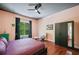 Bright bedroom featuring hardwood floors, a ceiling fan, and a large window with natural light at 2564 Walden Estates Dr, Marietta, GA 30062