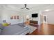 Large bedroom featuring hardwood floors, a ceiling fan, and an entertainment center with TV at 2564 Walden Estates Dr, Marietta, GA 30062