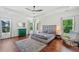 Spacious bedroom with hardwood floors, ample windows, and a comfortable seating area at 2564 Walden Estates Dr, Marietta, GA 30062