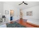 Bright bedroom featuring wood floors, a ceiling fan, with a peek into the attached bathroom at 2564 Walden Estates Dr, Marietta, GA 30062