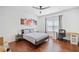 Cozy bedroom featuring wood floors, a ceiling fan, and a window providing lots of natural light at 2564 Walden Estates Dr, Marietta, GA 30062