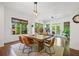 Bright dining room featuring hardwood floors, rustic table with seating, and a large window overlooking the trees at 2564 Walden Estates Dr, Marietta, GA 30062