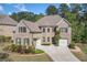 Beautiful brick house with lush landscaping, three car garage and charming architectural features at 2564 Walden Estates Dr, Marietta, GA 30062