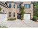 Charming brick home showcasing a three-car garage, a manicured lawn, and mature trees at 2564 Walden Estates Dr, Marietta, GA 30062