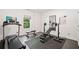 Home gym featuring a treadmill, weight bench, mirror, and rubber flooring for safe exercise in a private setting at 2564 Walden Estates Dr, Marietta, GA 30062