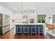 Modern kitchen with a large island, stainless steel appliances, pendant lights, and seating at 2564 Walden Estates Dr, Marietta, GA 30062