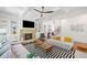Open-concept living room with hardwood floors, stone fireplace, built-in shelving, and modern ceiling fan at 2564 Walden Estates Dr, Marietta, GA 30062