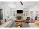 Stylish living room featuring a stone fireplace, built-in shelving, hardwood floors, and modern furniture at 2564 Walden Estates Dr, Marietta, GA 30062