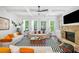 Bright living room with hardwood floors, a stone fireplace, a modern ceiling fan, and large windows at 2564 Walden Estates Dr, Marietta, GA 30062