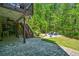 Beautiful stone patio with covered area and wooded view perfect for outdoor entertaining at 2564 Walden Estates Dr, Marietta, GA 30062