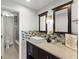This well-lit bathroom features a modern sink, decorative mirrors, stylish tiling, and a glass-enclosed shower at 3475 Oak Valley Road Ne # 870, Atlanta, GA 30326