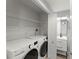Convenient laundry area featuring a washer, dryer, and storage shelves at 3475 Oak Valley Road Ne # 870, Atlanta, GA 30326