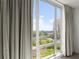 Stunning city views through a large window, framed by elegant curtains, showcase urban living at 3475 Oak Valley Road Ne # 870, Atlanta, GA 30326