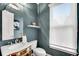 Powder room featuring white toilet and sink, silver mirror, and light blue walls at 3663 Brookhaven Manor Ne Xing, Atlanta, GA 30319