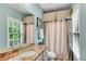 Cozy bathroom featuring granite countertops, decorative window treatment, and neutral walls at 3663 Brookhaven Manor Ne Xing, Atlanta, GA 30319
