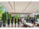 Deck with awning, outdoor seating, Weber grill, and lush green trees at 3663 Brookhaven Manor Ne Xing, Atlanta, GA 30319