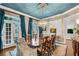 Bright dining room with hardwood floors, elegant chandelier, doors to deck, and designer wallpaper at 3663 Brookhaven Manor Ne Xing, Atlanta, GA 30319