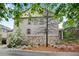Side view of townhome with stone accents and manicured landscaping at 3663 Brookhaven Manor Ne Xing, Atlanta, GA 30319