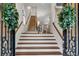 Inviting foyer showcasing a grand staircase with hardwood and carpet, and elegant decorations at 3663 Brookhaven Manor Ne Xing, Atlanta, GA 30319