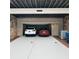 Two-car garage featuring a clean epoxy floor, brick veneer and ample parking space at 3663 Brookhaven Manor Ne Xing, Atlanta, GA 30319