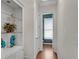 Hallway with hardwood floors leading to bathroom with built-in shelving at 3663 Brookhaven Manor Ne Xing, Atlanta, GA 30319