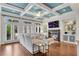 Cozy living room with a fireplace, coffered ceiling, and ample natural light, seamlessly flowing into the kitchen area at 3663 Brookhaven Manor Ne Xing, Atlanta, GA 30319
