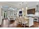 Open-concept living space with a modern kitchen, living room, and coffered ceilings that create an airy atmosphere at 3663 Brookhaven Manor Ne Xing, Atlanta, GA 30319
